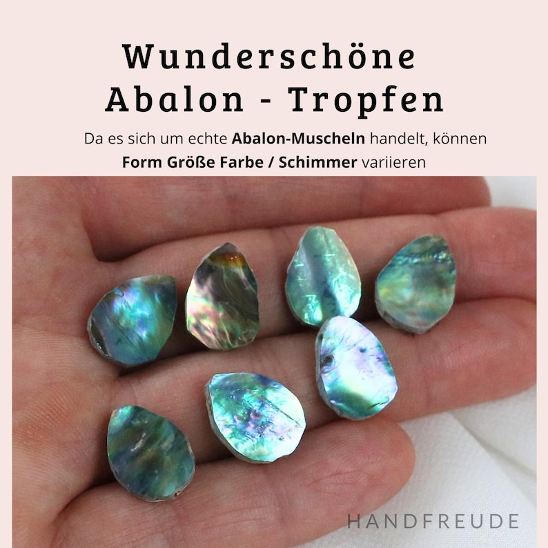 May include: A collection of seven iridescent abalone shell drops, each with a unique shape and colour variation. The shells are arranged in a hand, showcasing their natural beauty and shimmer.