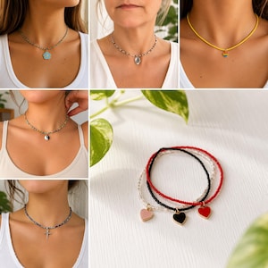 May include: A collection of beaded choker necklaces featuring various charms including a blue flower, a clear stone, a rainbow heart, a yin-yang symbol, a silver cross, and three heart-shaped pendants in pink, black, and red on beaded strands.