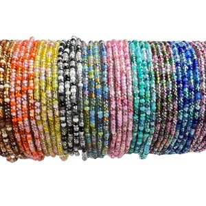 May include: A stack of colorful beaded bracelets in various shades of orange, yellow, white, gray, blue, green, and purple.