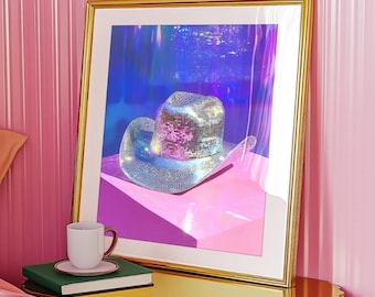 May include: A framed print of a silver sequined cowboy hat on a pink background. The hat is the focal point of the image and is surrounded by a blurred, iridescent background.