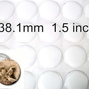 May include: A collection of clear, round, glass cabochons, each measuring 1.5 inches (38.1 mm) in diameter. The image includes a sample button with a vintage photograph design, labeled "Dixie Dazzle".