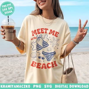 May include: A cream-coloured t-shirt with the text "MEET ME at the BEACH" in red and blue. The design features a bikini, starfish, seashells, and sunglasses. The image also includes a coffee drink in a clear cup.