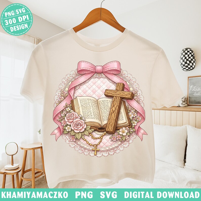 May include: A cream-colored t-shirt featuring a religious design. The design includes a pink bow, a wooden cross, an open book, roses, and a rosary. The words "PNG SVG 300 DPI DESIGN" are in the upper left corner. The words "KHAMIYAMACZKO PNG SVG DIGITAL DOWNLOAD" are at the bottom.