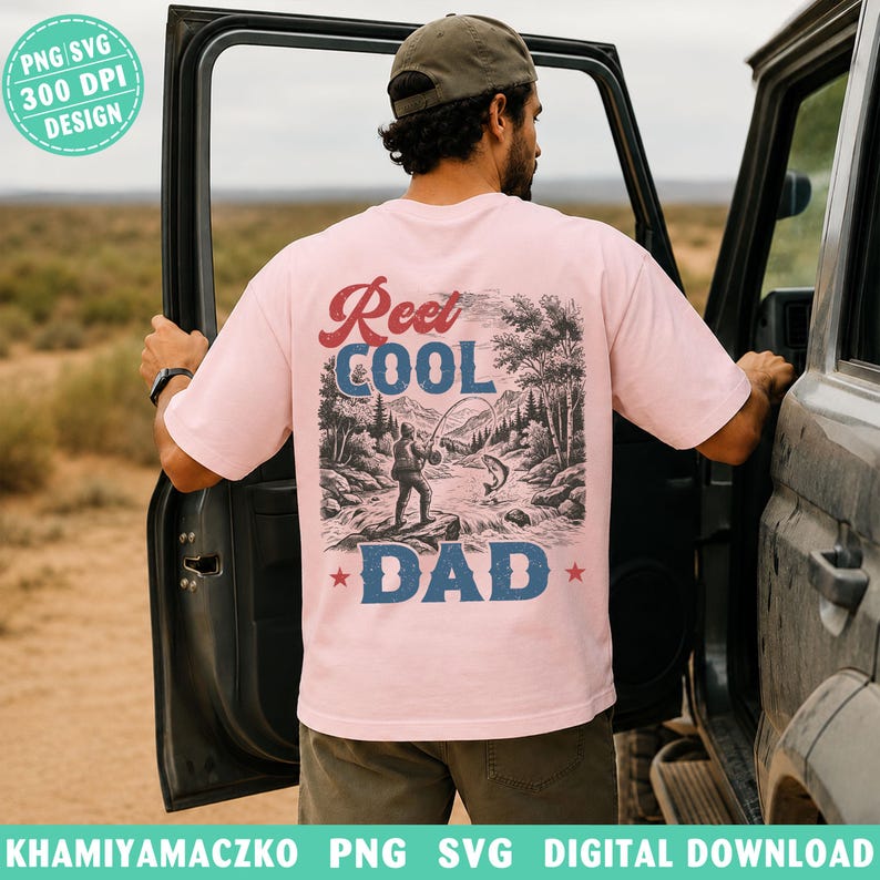 May include: Pale pink t-shirt featuring the text "Reel Cool Dad" above a fishing scene graphic. The graphic shows a fisherman, river, trees, and mountains. The shirt also has the text "PNG SVG 300 DPI DESIGN".