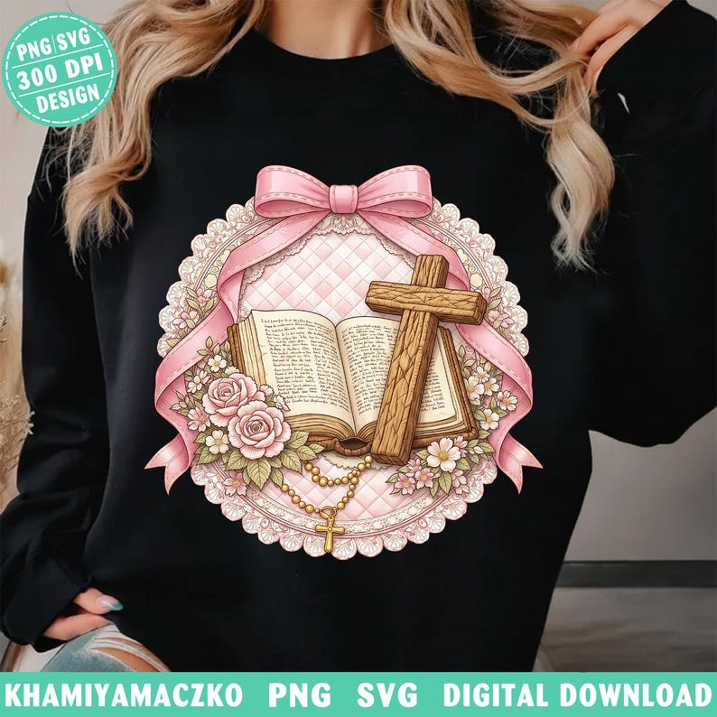 May include: Black sweatshirt featuring a religious design. The design includes an open book, a wooden cross, pink roses, and a rosary. A pink ribbon and lace frame the central image. The text "PNG SVG 300 DPI DESIGN" is in the upper left corner.
