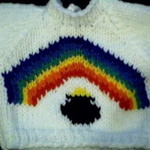 May include: White knitted baby sweater with a rainbow and a black pot of gold design.