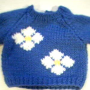 May include: A blue knitted baby sweater with white flower appliques.