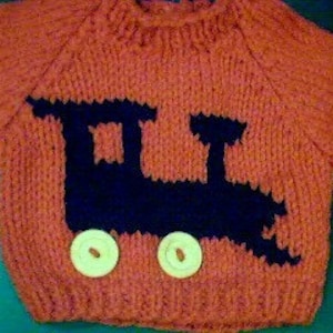 May include: A red knitted sweater with a black train design and two yellow buttons. The train has a black chimney and two black wheels.