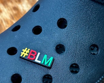 May include: Black Crocs clog with a #BLM charm attached to the front strap.