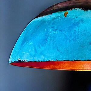 May include: A blue and orange lampshade with a textured surface.