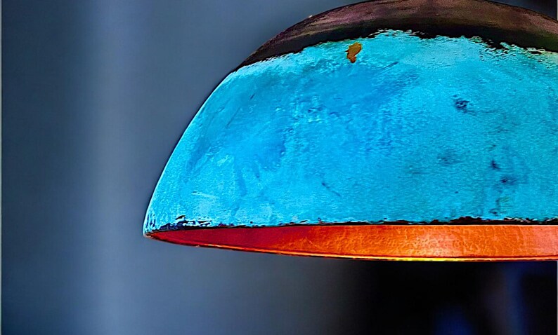 May include: A blue and orange lampshade with a textured surface.