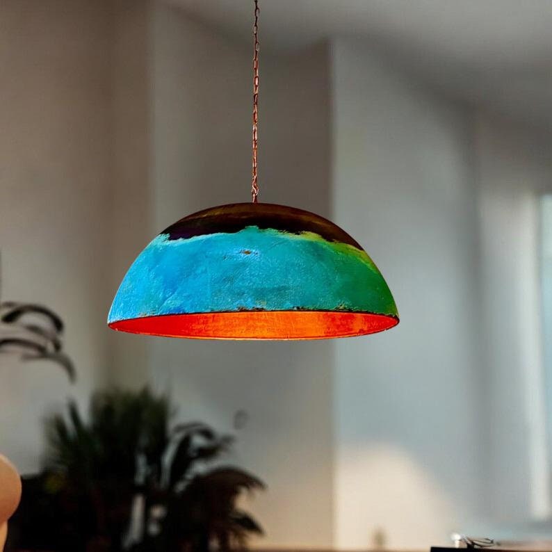 May include: A colorful, dome-shaped pendant light fixture with a blue, green, and orange paint design. The light fixture is hanging from a chain.