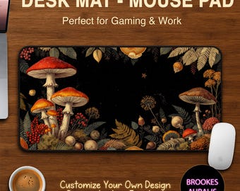 May include: Rectangular desk mat with a mushroom design. The mat features a black background with illustrations of red and orange mushrooms, ferns, and foliage. The text "DESK MAT - MOUSE PAD" and "Customize Your Own Design" are visible.