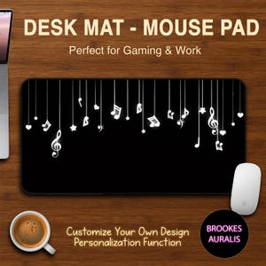 May include: Black desk mat with white musical notes and symbols hanging from the top. The mat has the text "DESK MAT - MOUSE PAD" and "Perfect for Gaming & Work". The mat also has the text "Customize Your Own Design Personalization Function".