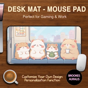 May include: A rectangular desk mat with a cartoon illustration of four cute hamsters on a train. The mat has the text "DESK MAT - MOUSE PAD" and "Perfect for Gaming & Work". A white mouse and a cup of coffee are also visible.