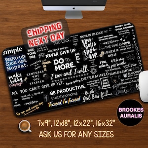 May include: Black rectangular desk mat with white motivational quotes. The mat includes phrases such as "Never give up" and "Be productive." Available sizes: 17.78 x 22.86 cm, 30.48 x 45.72 cm, 30.48 x 55.88 cm, and 40.64 x 81.28 cm.