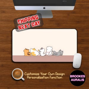 May include: A rectangular mousepad with a light beige surface and a row of cartoon cats in various colors. The mousepad has a brown border and the text "Customize Your Own Design Personalization Function".