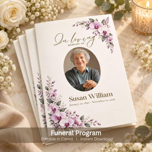 May include: A funeral program booklet featuring a white cover with purple orchid floral illustrations, the text In loving memory of, a central oval photograph of an older person, and the name Susan William with the dates January 10, 1890 - November 10, 2026.