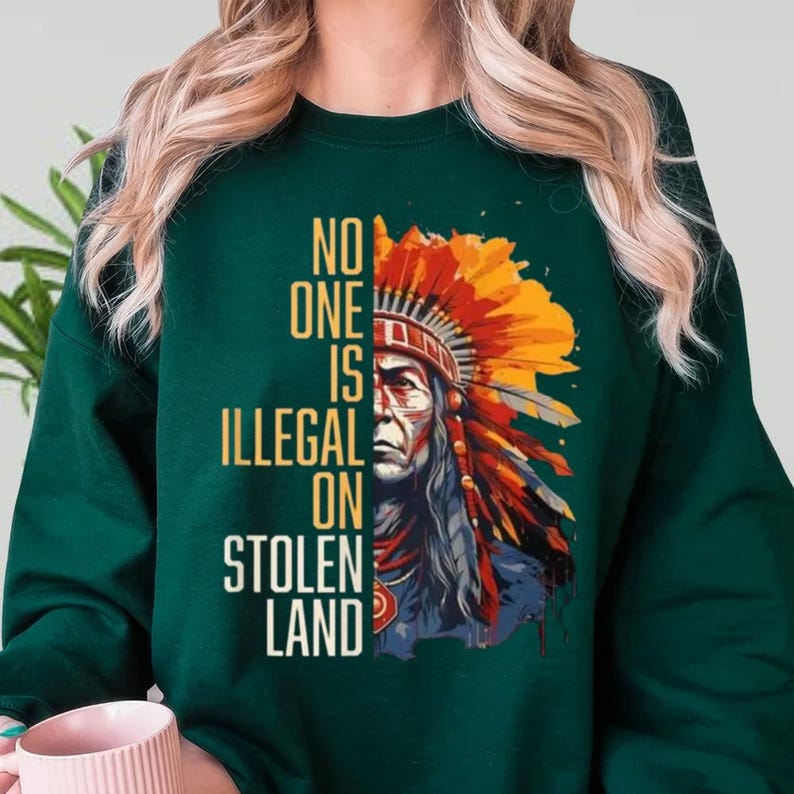 a woman wearing a green sweatshirt with an indian headdress