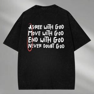 May include: Black t-shirt with white text that reads "Agree with God, Move with God, End with God, Never Doubt God". The text is circled in red.