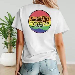 a woman wearing a white t - shirt with a rainbow slogan