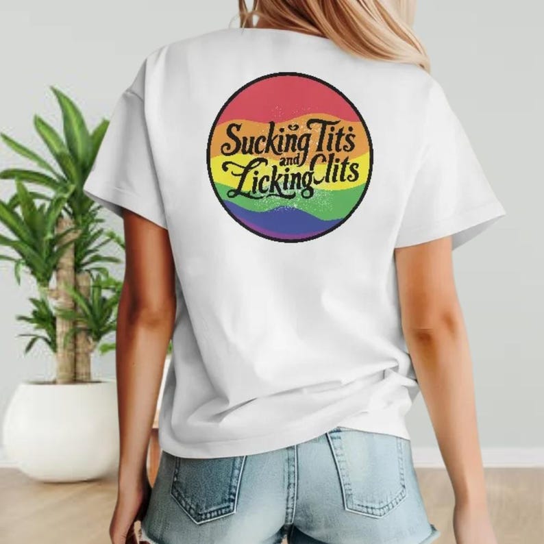 a woman wearing a white t - shirt with a rainbow slogan