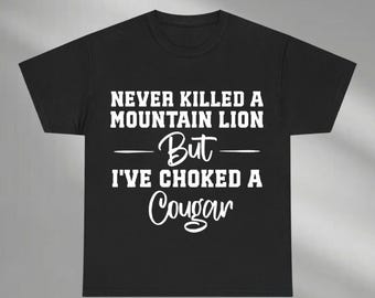 May include: Black t-shirt with white text that reads "Never killed a mountain lion but I've choked a cougar".