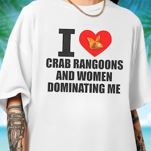 May include: White t-shirt with the text "I ❤️ Crab Rangoons and Women Dominating Me" in black. The heart symbol is red and contains a graphic of a crab rangoon.