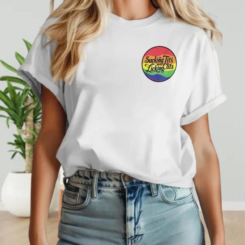 a woman wearing a white t - shirt with a rainbow logo