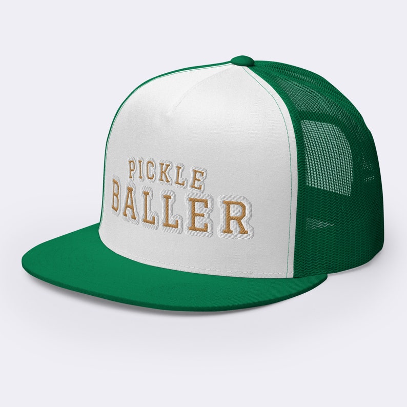 May include: White and green trucker hat with a gold embroidered logo that says "Pickle Baller".