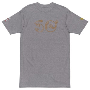 May include: A heather grey t-shirt with a brown outline of a microphone and a record player on the front. The design is stylized to look like the letters "SO".