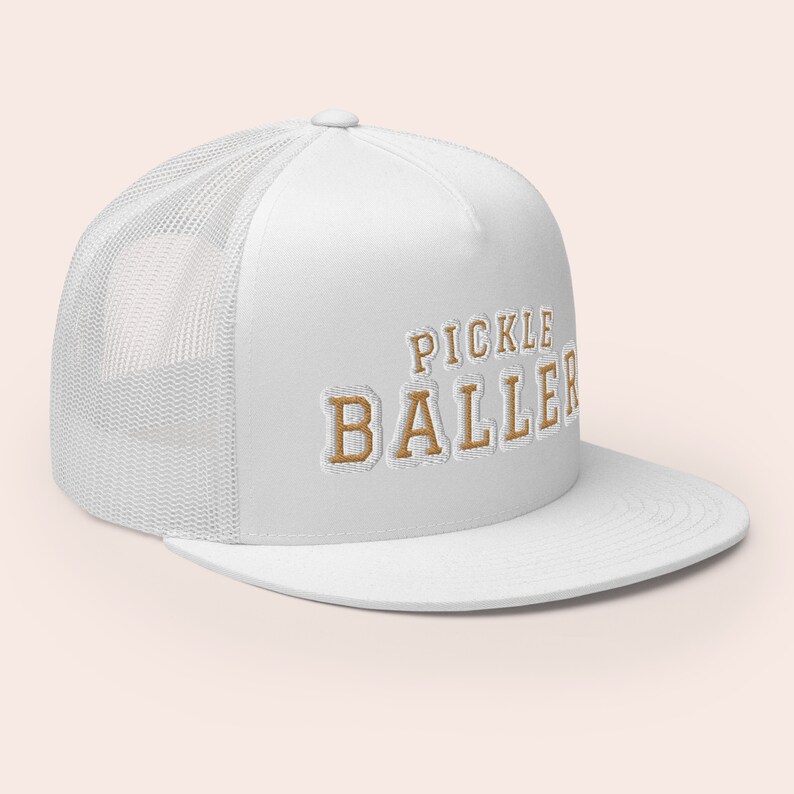 May include: White trucker hat with a brown embroidered logo that says "Pickle Baller".