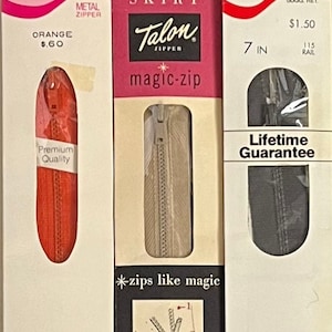 May include: Three Talon brand zippers in their original packaging. One is orange, 7 inches (18 cm) long, and labeled "Metal Zipper." Another is beige, for skirts, and the third is black, also 7 inches (18 cm) long, with a lifetime guarantee.