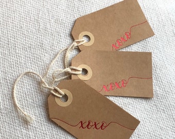 Glowing XOXO love tags in assorted sizes and colors, great for wedding favors, gifts attaching surprise hugs & kisses 100% recycled paper