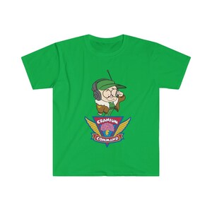 May include: Vibrant green t-shirt with a cartoon character in a green cap and aviator jacket, holding a radio. The design includes a "Cranium Command" logo with a brain graphic.