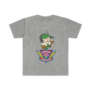 May include: A grey t-shirt with a cartoon character wearing a green hat and headset. The character is above a colourful emblem with the words "Cranium Command" and a brain graphic.