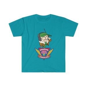 May include: A turquoise t-shirt with a cartoon character in a green cap and aviator gear, holding a radio. Below is a logo with a brain graphic, wings, and the words "Cranium Command".