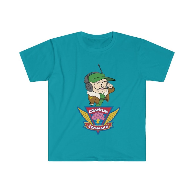 May include: A turquoise t-shirt with a cartoon character in a green cap and aviator gear, holding a radio. Below is a logo with a brain graphic, wings, and the words "Cranium Command".