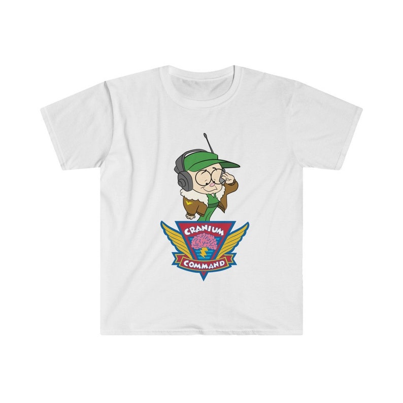 May include: White t-shirt with a cartoon character wearing a green cap and headset. The design includes the text "Cranium Command" and a brain graphic with wings. The shirt is made of a soft material. A fun, casual tee.