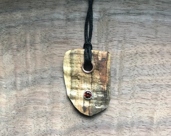 Spalted curly maple pendant with garnet gemstone
