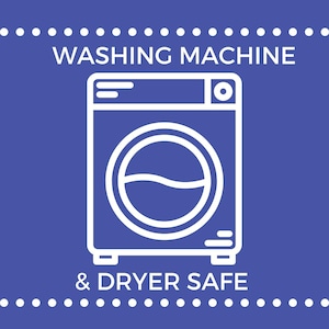 May include: A square purple graphic featuring a white line-art icon of a front-loading washing machine. The text WASHING MACHINE is centered above the icon, and the text & DRYER SAFE is centered below it, framed by horizontal dotted lines.