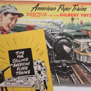 May include: A vintage advertisement for American Flyer Trains, featuring a colorful illustration of a train set with a locomotive, passenger cars, and a track layout. The ad also includes the text "American Flyer Trains, Erector and Other Gilbert Toys."