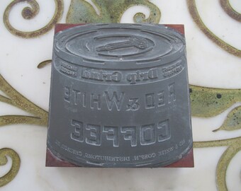 May include: A vintage metal printing block with the text "Red & White Coffee Drip Grind" and the company name "J.L. CORP'N. DISTRIBUTORS, CHICAGO, ILL."