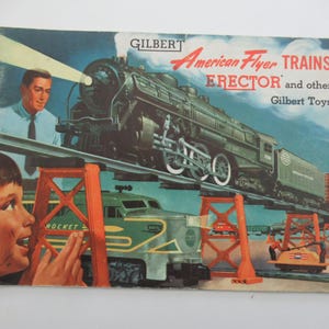 May include: Vintage Gilbert American Flyer Trains ERECTOR and other Gilbert Toys catalog cover. The cover features a detailed illustration of a green and black train on a track, with a man and a boy looking at the train.