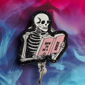 May include: A black and white skeleton wearing a black glitter badge holder with a pink book that says "How to be a Nurse".