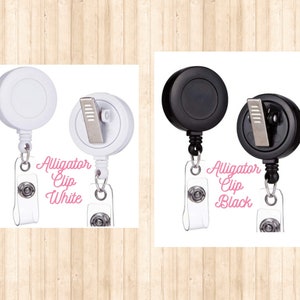 May include: Two retractable badge holders, one white and one black, with alligator clips and the text "Alligator Clip White" and "Alligator Clip Black".