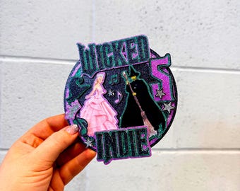 Wicked style Glinda and Elphaba 3D glitter cake topper