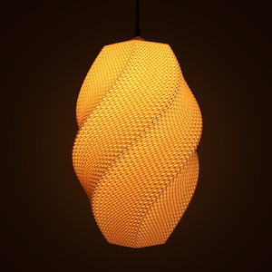 May include: A yellow pendant light with a woven texture, hanging from a black cord. The light has a twisted, elongated form. The light fitting is against a dark background and emits a warm glow, creating a soft ambiance.