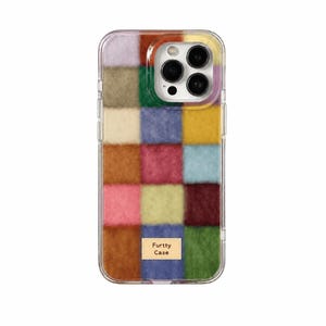 May include: A smartphone case featuring a multi-coloured chequered pattern with a fuzzy, textured surface. The squares include shades of brown, pink, yellow, blue, green, and red. A small rectangular label on the lower section reads Furtty Case.