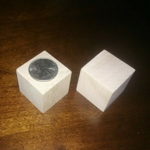 May include: Two unfinished wooden blocks, one with a US quarter on top, showing the size of the blocks.